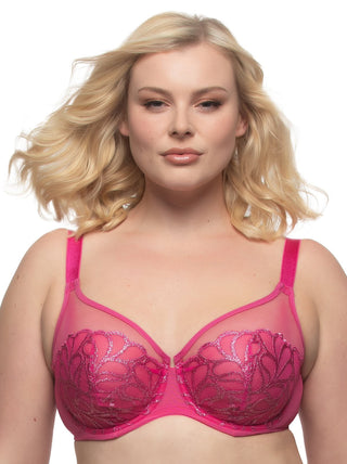 Mackenzie - A woman wearing a pink unlined embroidered bra with a clean neckline.