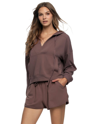 Daria Woman wearing a brown hoodie and shorts set on a white background