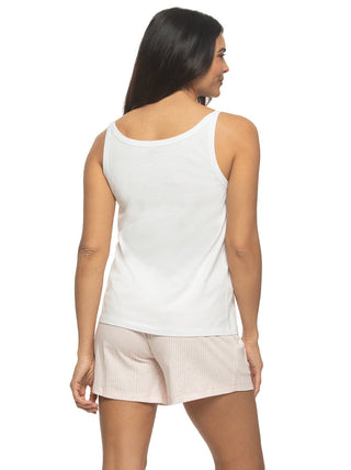 Woman wearing a white tank top and light pink shorts on a plain background -back view