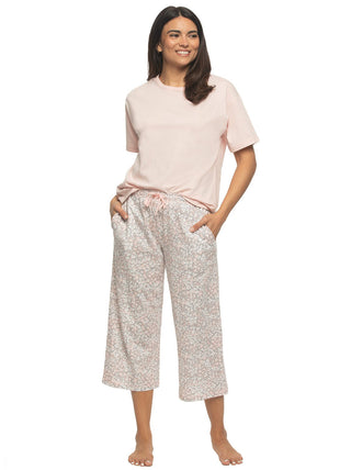 Kyra - Women wearing a pink tshirt, and pink floral pajama pants.