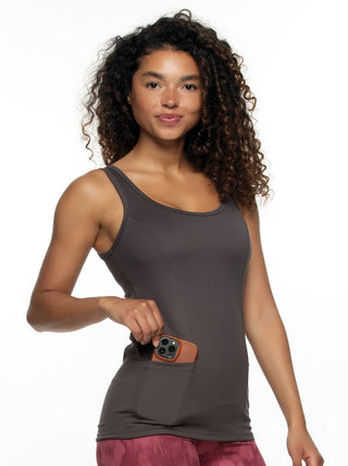 Quinn A woman wearing a gray Athletic Tank Top with a smartphone in the shirt side pocket