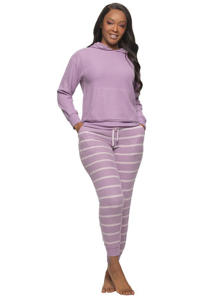 Anala Woman wearing a purple hoodie and purple pants with white stripes on a white background