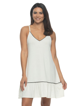 Kyra A woman wearing a with chemise with adjustable straps and a ruffle bottom.