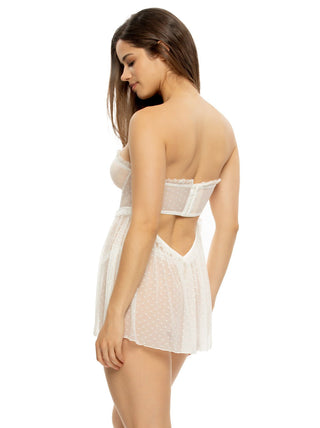 Woman wearing a white lace babydoll with cut-out back design on a white background
