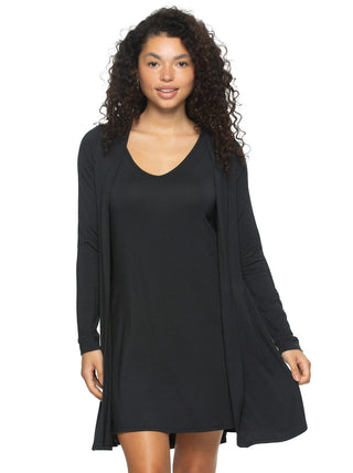 Quinn A woman wearing a black modal tank chemise and wrap set with a V-neckline and long sleeves.