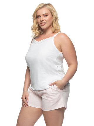 Mackenzie Full figure woman wearing white tank top and pink pajama shorts