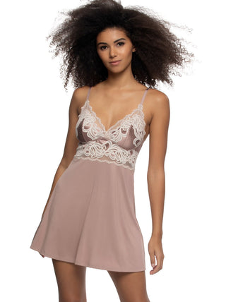Birta Woman wearing a pink lace-trimmed camisole nightgown on a white background