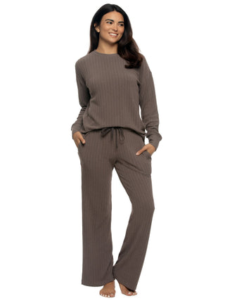 Kyra - Woman wearing a brown ribbed lounge set on a white background