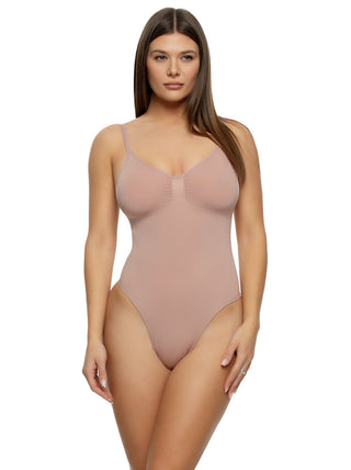 Victoria A woman wearing a beige thong bodysuit with adjustable straps front view