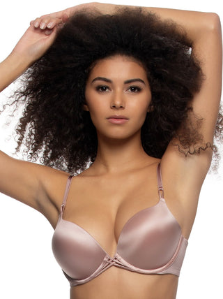 Birta - Woman wearing a nude push up bra against a white background