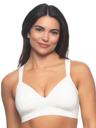 Kyra - A woman wearing a white wire-free bra with a smooth neckline and wide straps.