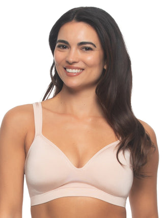 Kyra - A woman wearing a neutral color wire-free bra with a smooth neckline and wide straps.