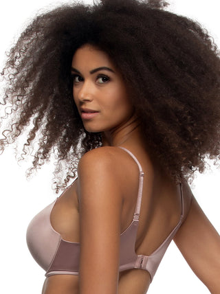 Woman wearing a beige bra against a white background