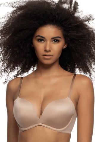 A person with dark, curly hair is wearing a Moxie Seamless Side Smoothing Push Up Bra by Felina in color Dune.